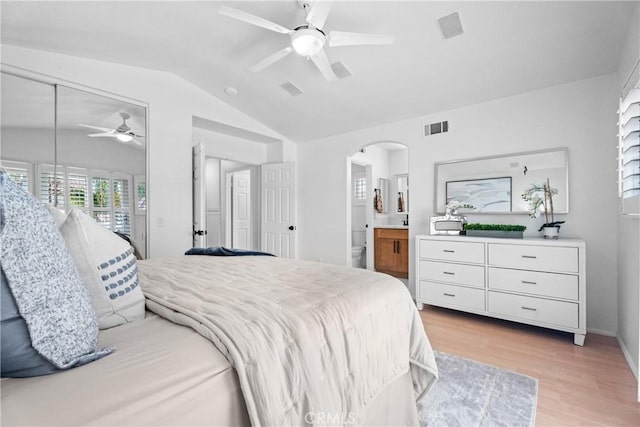 2 Chestnut Dr, Aliso Viejo, CA 92656 - bedroom featuring lofted ceiling, arched walkways, light wood-style flooring, a ceiling fan, and ensuite bath