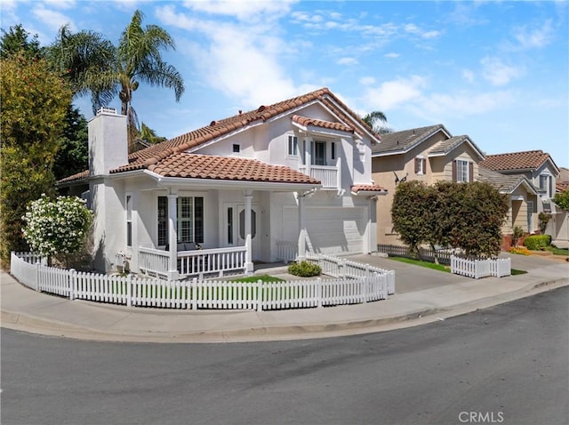 2 Chestnut Dr, Aliso Viejo, CA 92656 - mediterranean / spanish-style home with a tile roof, a porch, a fenced front yard, a chimney, and an attached garage