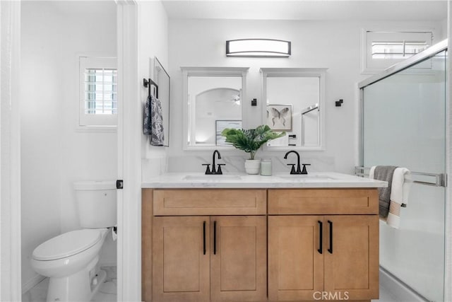 2 Chestnut Dr, Aliso Viejo, CA 92656 - bathroom featuring double vanity, toilet, a stall shower, and baseboards