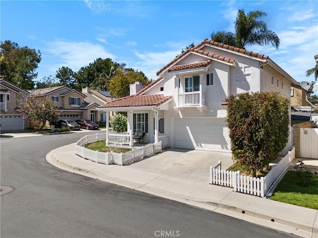 2 Chestnut Dr, Aliso Viejo, CA 92656 - mediterranean / spanish-style home featuring a tiled roof, a garage, stucco siding, driveway, and a residential view