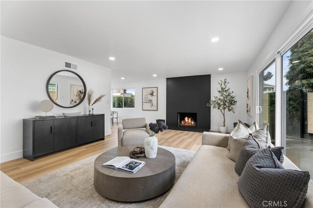 109 Loyola, Seal Beach, CA 90740 - living area with plenty of natural light, recessed lighting, wood finished floors, and a large fireplace