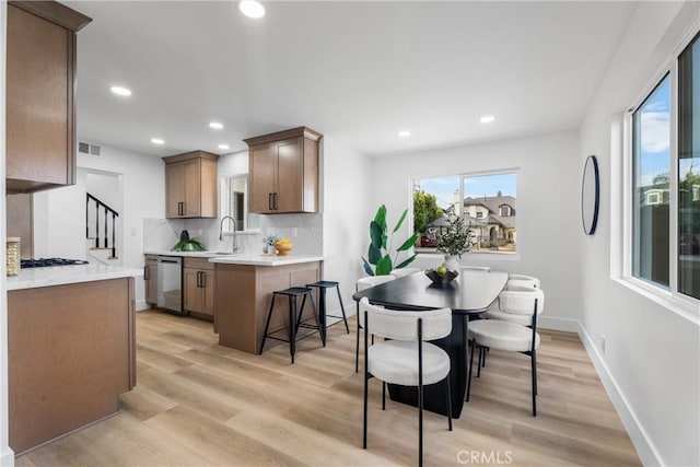 109 Loyola, Seal Beach, CA 90740 - kitchen featuring stainless steel dishwasher, light wood-style floors, recessed lighting, backsplash, and a peninsula