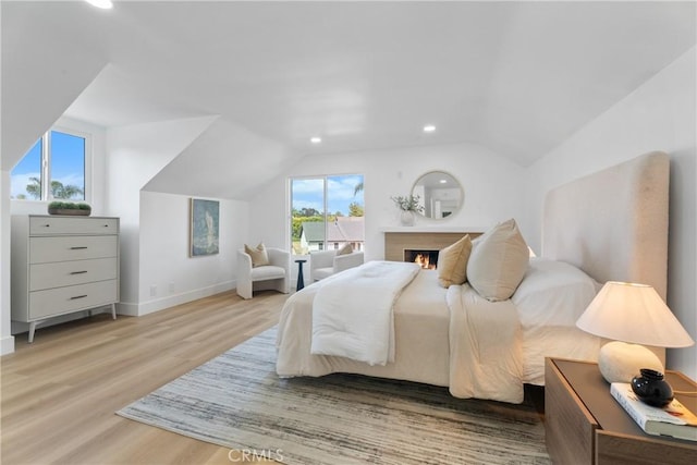 109 Loyola, Seal Beach, CA 90740 - bedroom with vaulted ceiling, recessed lighting, light wood-type flooring, baseboards, and a lit fireplace