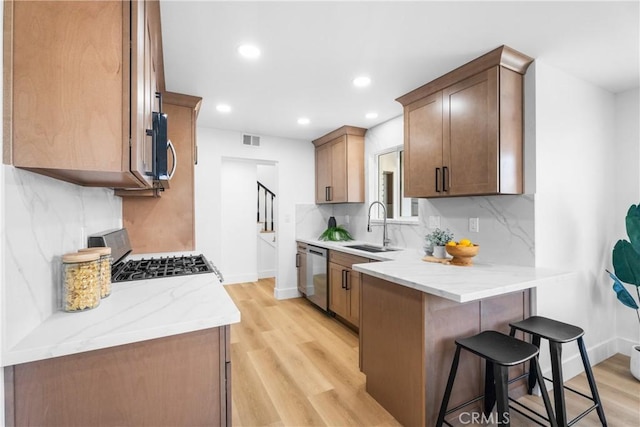 109 Loyola, Seal Beach, CA 90740 - kitchen featuring stainless steel appliances, a sink, decorative backsplash, light wood-type flooring, and recessed lighting