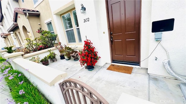 2652 W Madison Cir, Anaheim, CA 92801 - view of exterior entry featuring stucco siding and a porch