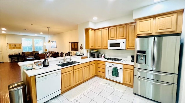 2652 W Madison Cir, Anaheim, CA 92801 - kitchen featuring white appliances, a peninsula, open floor plan, light brown cabinets, and a sink