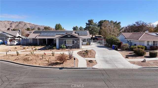 16395 Cuyama Way, Apple Valley, CA 92307 - ranch-style home featuring concrete driveway, solar panels, a mountain view, and fence