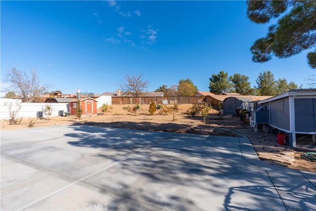 16395 Cuyama Way, Apple Valley, CA 92307 - view of yard with a shed, an outdoor structure, fence, and a residential view