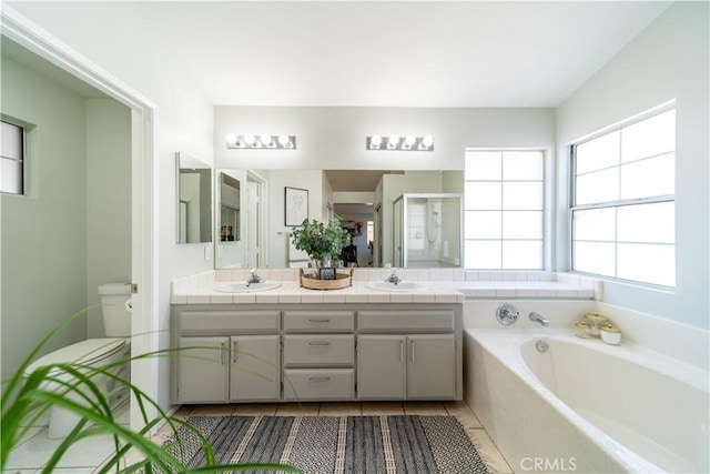 16395 Cuyama Way, Apple Valley, CA 92307 - bathroom featuring a shower stall, double vanity, a garden tub, toilet, and tile patterned floors