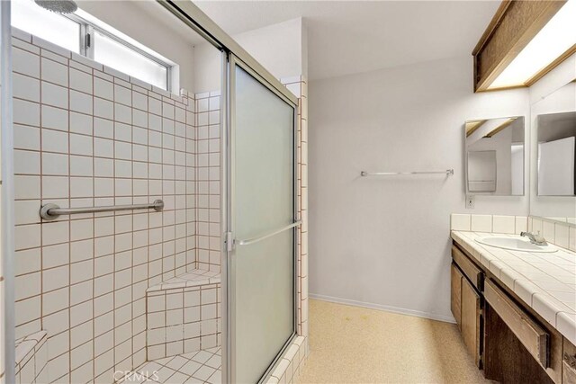 7621 Alston Ave, Hesperia, CA 92345 - bathroom featuring a shower stall, vanity, and baseboards
