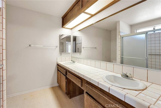 7621 Alston Ave, Hesperia, CA 92345 - bathroom with double vanity, baseboards, and a shower stall