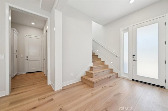 56 Chasma, Irvine, CA 92618 - foyer with light wood finished floors, recessed lighting, stairway, and baseboards