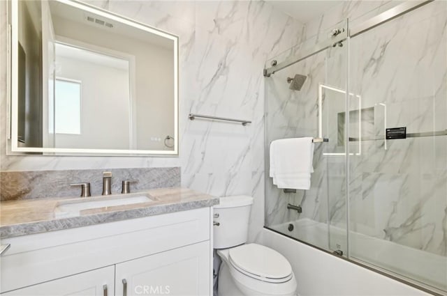 56 Chasma, Irvine, CA 92618 - bathroom featuring vanity, bath / shower combo with glass door, toilet, and tile walls