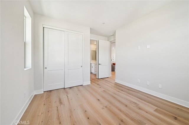 56 Chasma, Irvine, CA 92618 - unfurnished bedroom featuring baseboards, light wood-style flooring, a closet, and ensuite bath