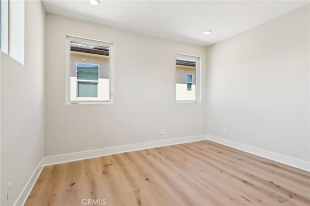 56 Chasma, Irvine, CA 92618 - spare room featuring wood finished floors, healthy amount of natural light, baseboards, and recessed lighting