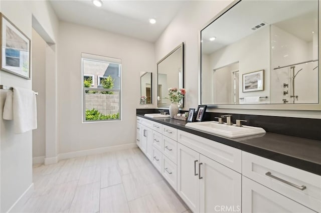 56 Chasma, Irvine, CA 92618 - bathroom with baseboards, double vanity, recessed lighting, and a shower