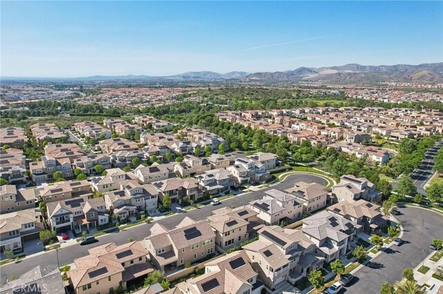 56 Chasma, Irvine, CA 92618 - aerial view of property's location featuring a mountain backdrop and nearby suburban area