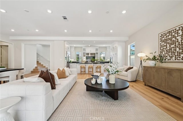 56 Chasma, Irvine, CA 92618 - living area featuring light wood-style flooring, stairs, and recessed lighting