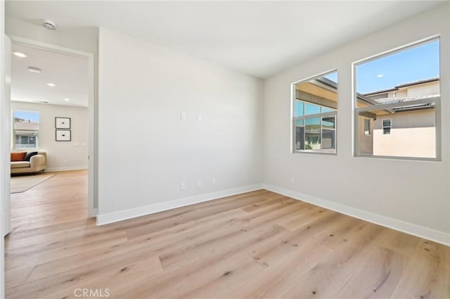 56 Chasma, Irvine, CA 92618 - empty room featuring plenty of natural light, wood finished floors, baseboards, recessed lighting, and a smoke detector