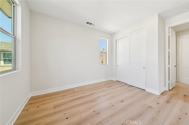 56 Chasma, Irvine, CA 92618 - unfurnished bedroom featuring light wood-style floors, baseboards, and a closet