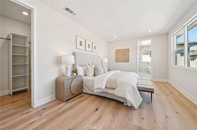 56 Chasma, Irvine, CA 92618 - bedroom with light wood-style floors, baseboards, recessed lighting, and ensuite bath