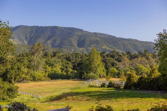 view of mountain background with a forest and rural landscape