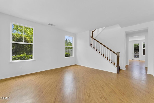 40197 Gallatin Ct, Temecula, CA 92591 - unfurnished living room featuring plenty of natural light, light wood finished floors, stairs, and baseboards