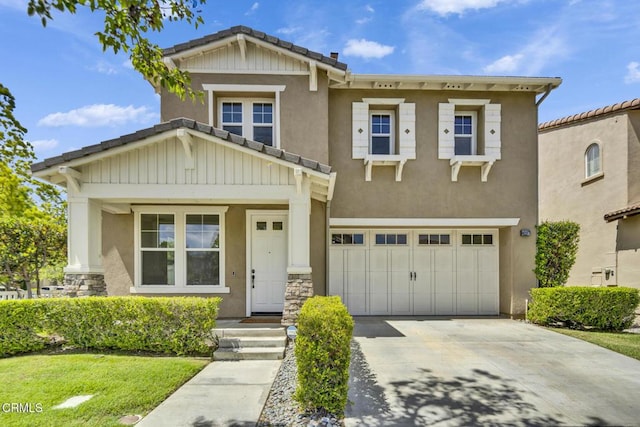 40197 Gallatin Ct, Temecula, CA 92591 - craftsman-style home featuring an attached garage, driveway, stucco siding, and stone siding