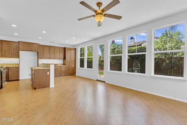 40197 Gallatin Ct, Temecula, CA 92591 - unfurnished living room with light wood-style floors, recessed lighting, ceiling fan, a sink, and baseboards