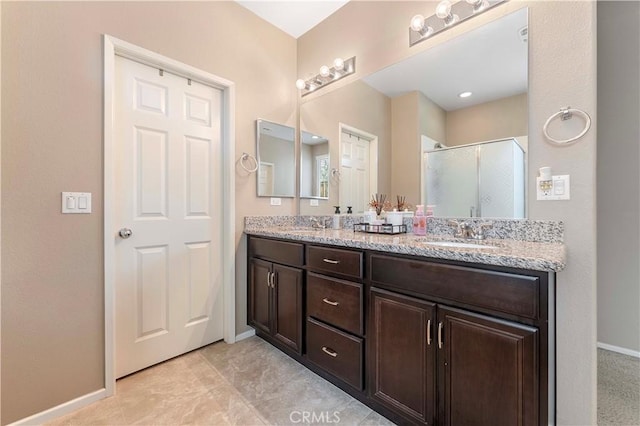 45019 Carla Ct, Lake Elsinore, CA 92532 - bathroom featuring a shower stall, double vanity, and baseboards