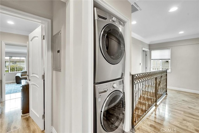1826 N Berendo St, Los Angeles, CA 90027 - washroom featuring stacked washing machine and dryer, light wood-style flooring, ornamental molding, and recessed lighting