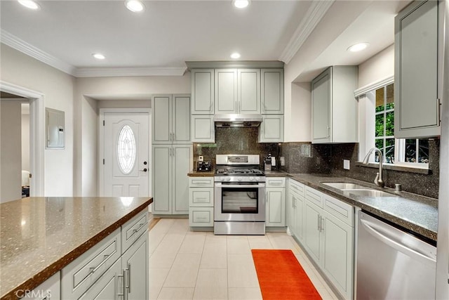 1826 N Berendo St, Los Angeles, CA 90027 - kitchen with appliances with stainless steel finishes, under cabinet range hood, crown molding, tasteful backsplash, and recessed lighting