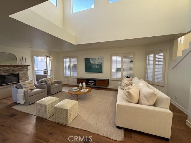 854 Cypress Ave, Hermosa Beach, CA 90254 - living room with wood finished floors, healthy amount of natural light, a fireplace, and a high ceiling