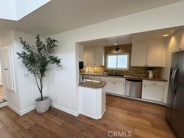 854 Cypress Ave, Hermosa Beach, CA 90254 - kitchen featuring appliances with stainless steel finishes, dark wood-style floors, baseboards, and decorative backsplash