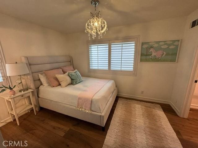 854 Cypress Ave, Hermosa Beach, CA 90254 - bedroom featuring dark wood-style flooring, baseboards, and a chandelier