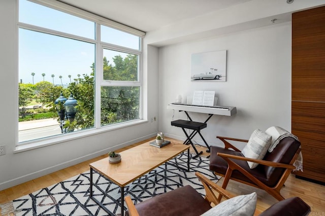 living area with plenty of natural light and baseboards