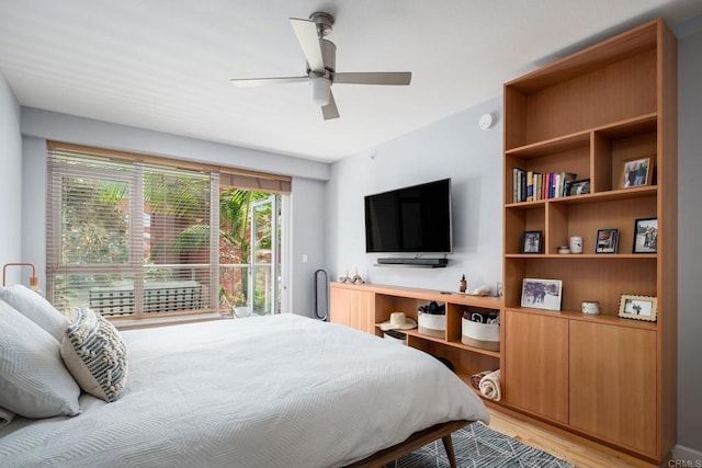 bedroom featuring light wood-style flooring, ceiling fan, and access to outside