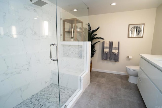 bathroom with a marble finish shower, toilet, vanity, recessed lighting, and baseboards