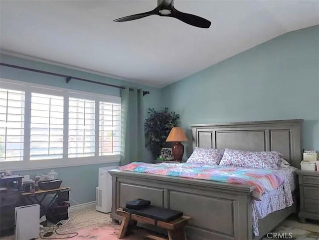 bedroom with lofted ceiling, ceiling fan, and baseboards