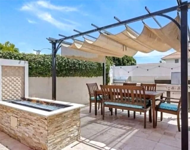 view of patio / terrace with outdoor dining space, a pergola, and fence
