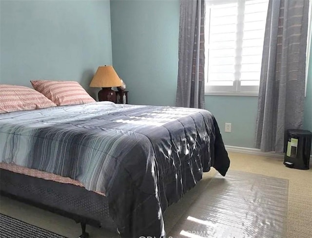 bedroom featuring carpet and baseboards