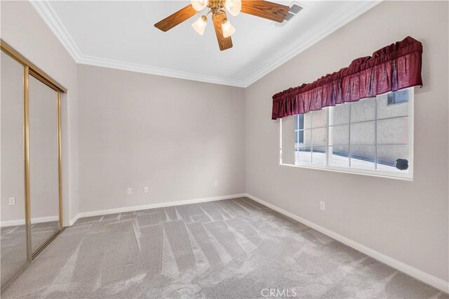 23651 Cruise Circle Dr, Canyon Lake, CA 92587 - unfurnished bedroom featuring ornamental molding, carpet floors, baseboards, and a closet