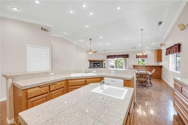 23651 Cruise Circle Dr, Canyon Lake, CA 92587 - kitchen featuring a spacious island, a lit fireplace, a sink, light wood-style floors, and tile counters
