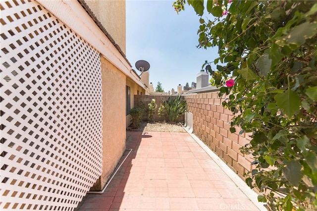 1434 Senator Way, San Jacinto, CA 92583 - view of side of home featuring a fenced backyard, stucco siding, and a patio area