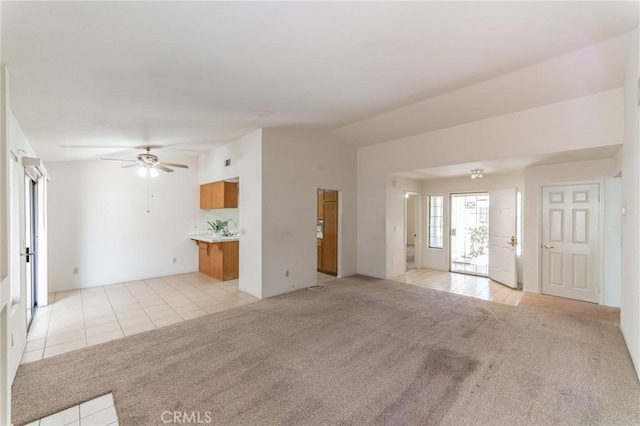 1434 Senator Way, San Jacinto, CA 92583 - unfurnished living room with light colored carpet, a ceiling fan, light tile patterned flooring, and lofted ceiling