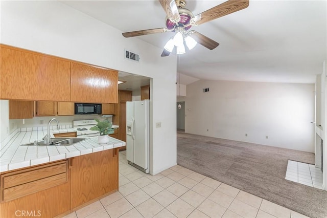 1434 Senator Way, San Jacinto, CA 92583 - kitchen featuring tile countertops, white appliances, a sink, vaulted ceiling, and light colored carpet
