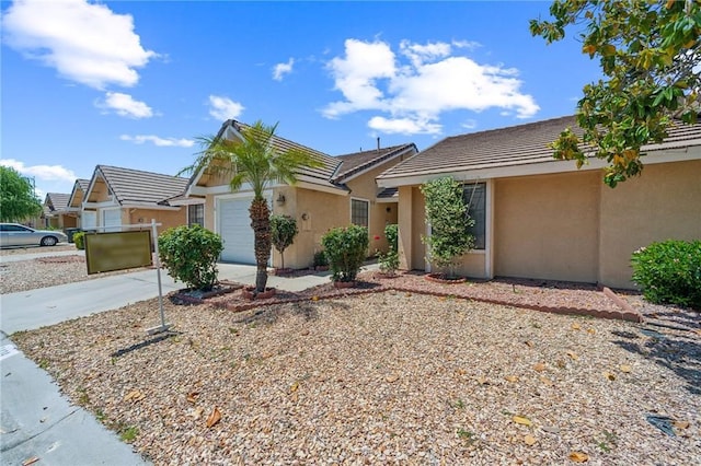 1434 Senator Way, San Jacinto, CA 92583 - view of front facade with stucco siding, an attached garage, driveway, and a tile roof