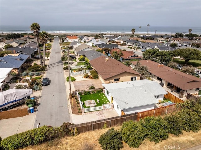 aerial view of residential area featuring a large body of water