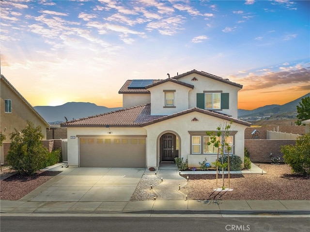 29628 Dotted Mint, Winchester, CA 92596 - mediterranean / spanish-style house featuring stucco siding, a mountain view, a garage, solar panels, and concrete driveway