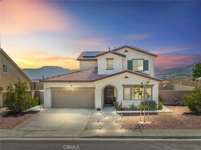 29628 Dotted Mint, Winchester, CA 92596 - mediterranean / spanish-style home with stucco siding, a garage, a mountain view, roof mounted solar panels, and driveway